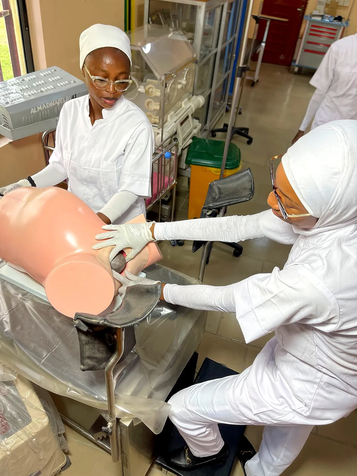 Student nurse holding an infant training manikin
