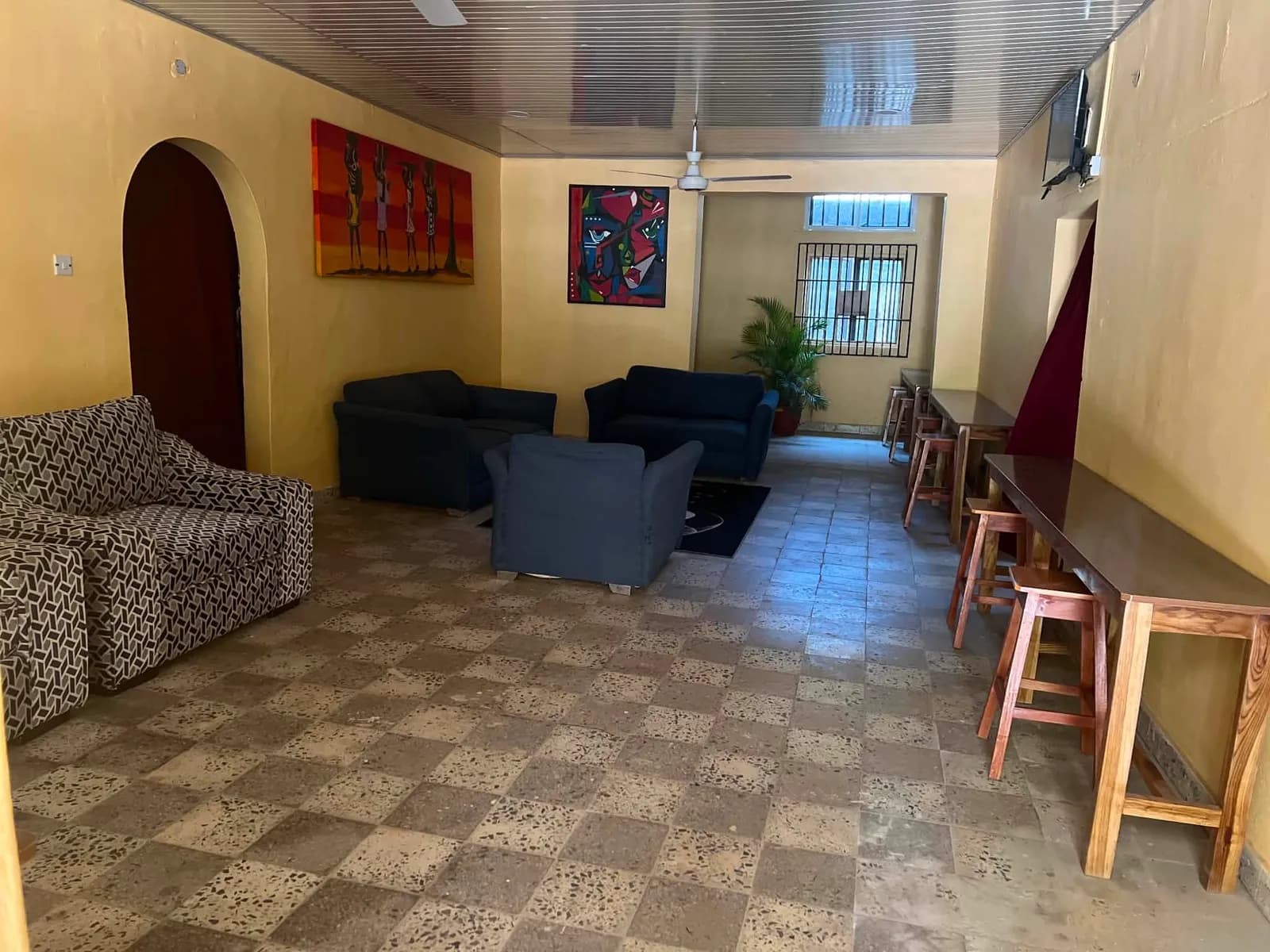The student common room, with sofas, high tables and stools under a tiled ceiling