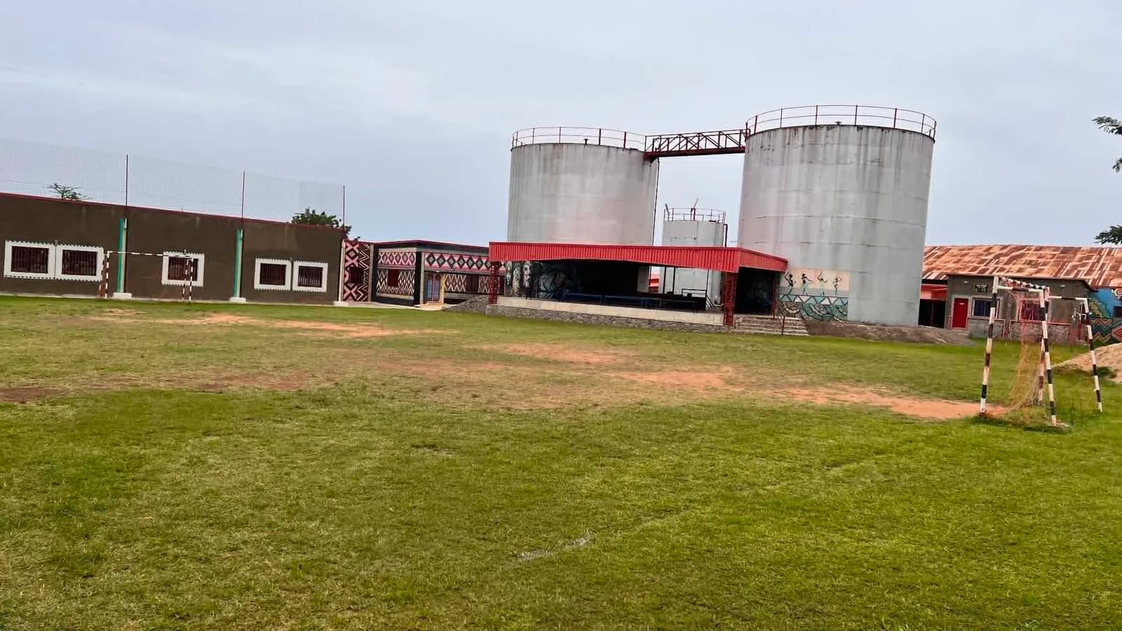 Wide view across the five-a-side football pitch and the covered stand at Almadina College