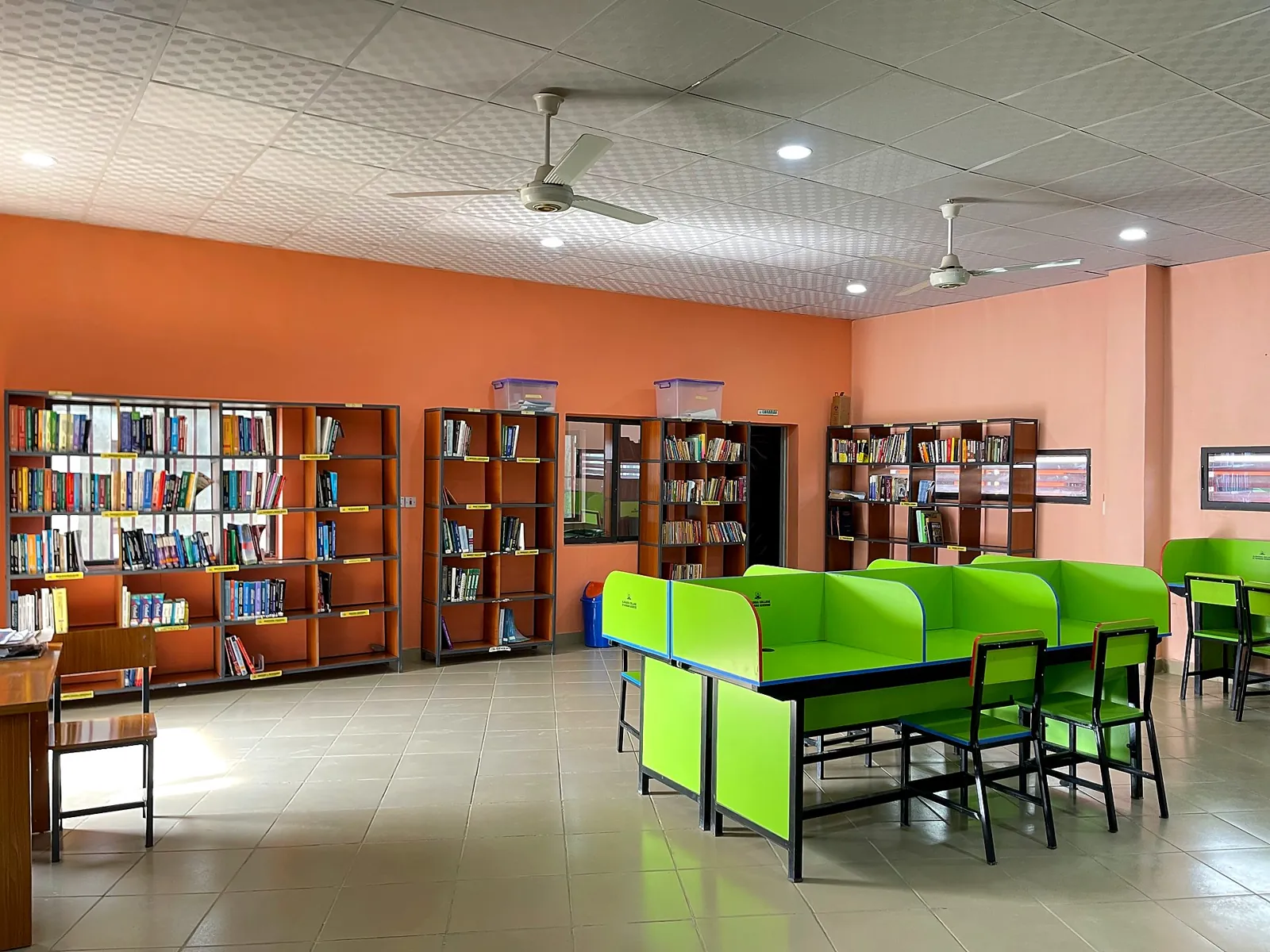 The ICT laboratory with rows of green desks