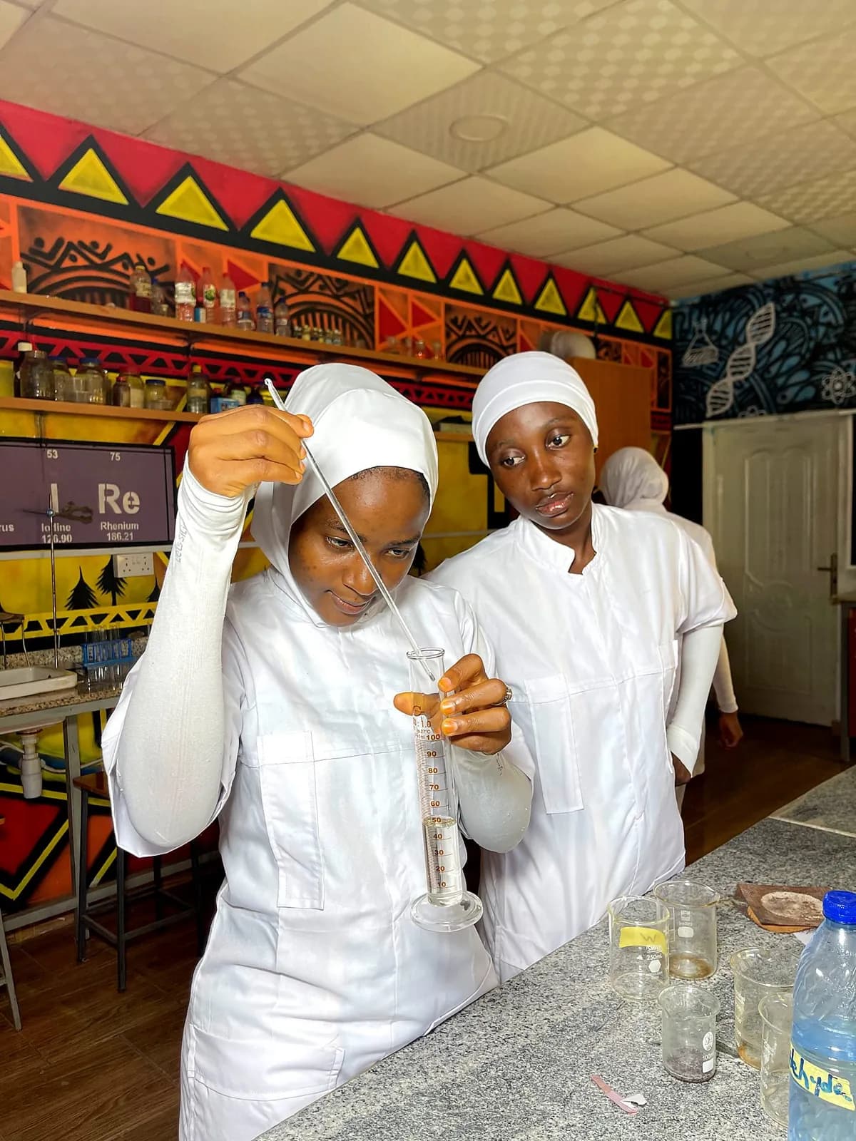 Student nurses measuring a solution in the science laboratory