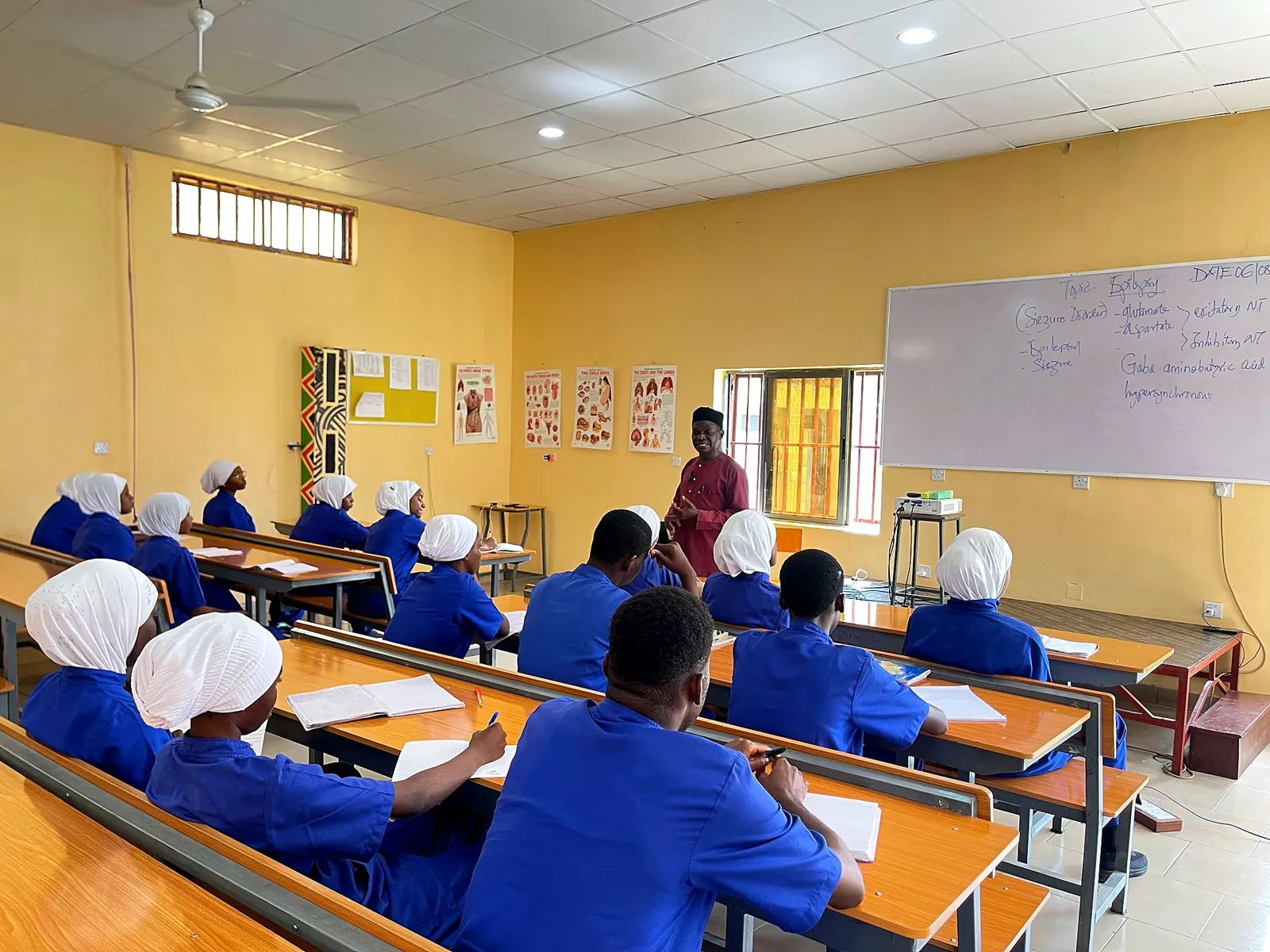 Lecture in progress with students in blue scrubs