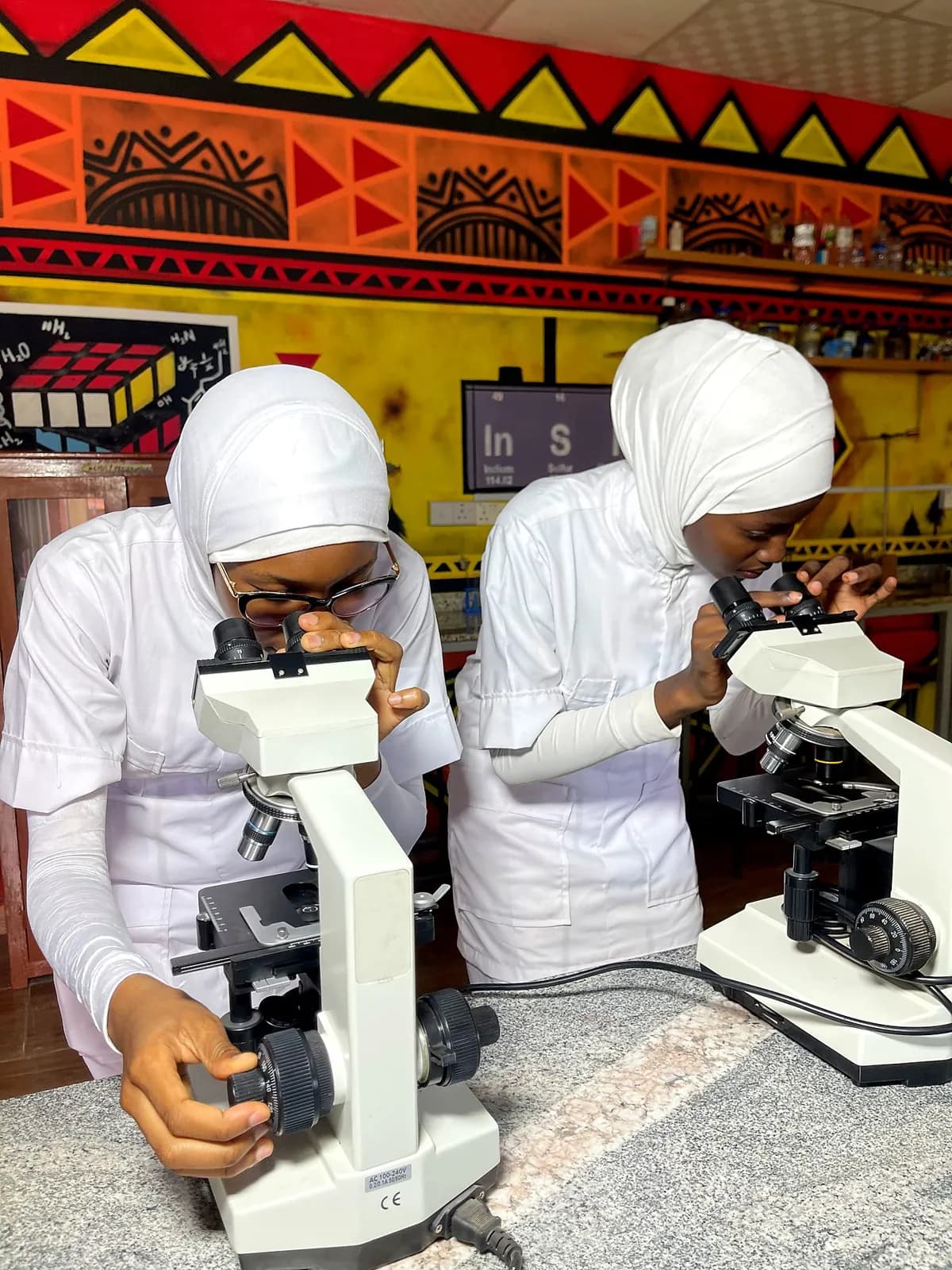 Student nurse using a microscope in the science laboratory