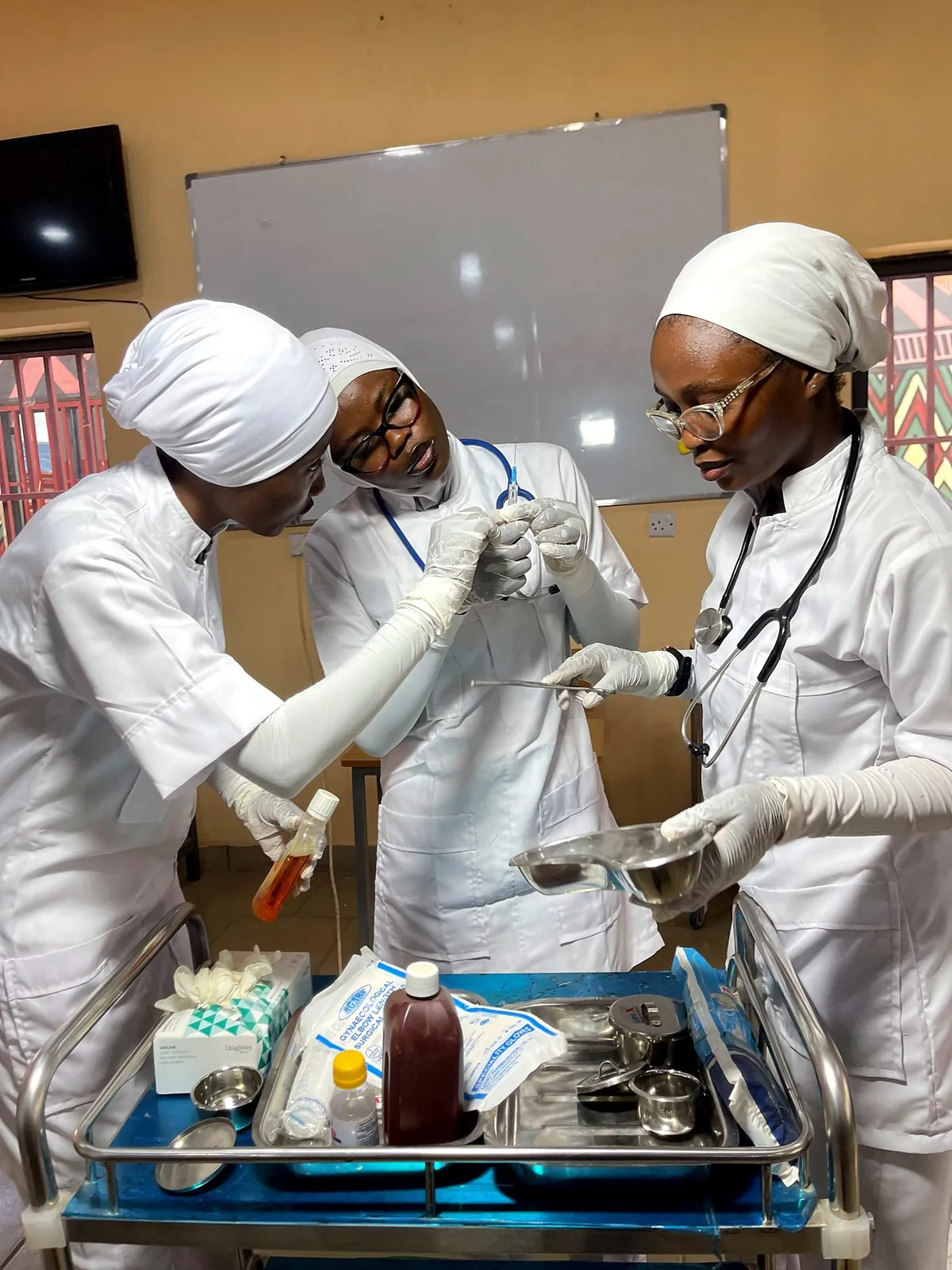 Student nurses preparing a procedure trolley together